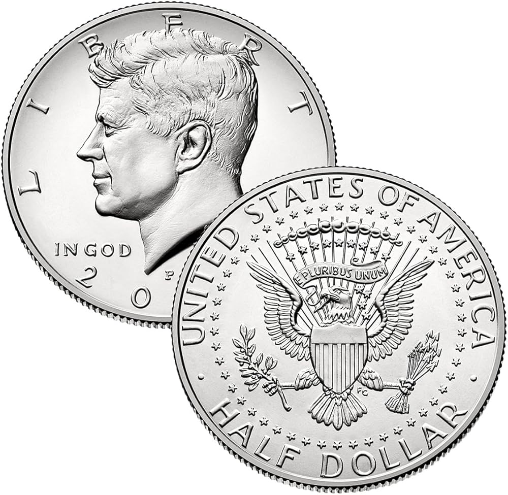 2005 Kennedy half dollar grading strip showing Worn, About Uncirculated, MS-65, and MS-67 examples side by side